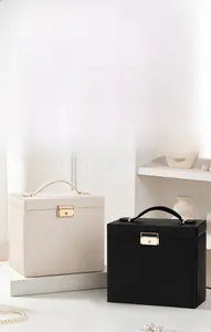 Elegant handheld jewelry box storage with gold locks in cream white and black leather