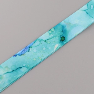 Detail of blue and green marble pattern fabric lanyard with abstract ink textures