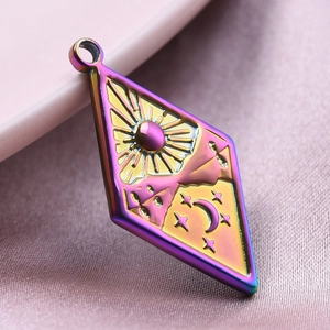 Macro view of a rainbow-plated diamond pendant with sun and moon engravings
