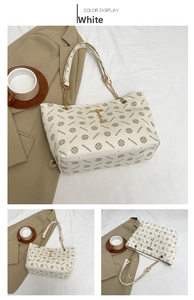 Detail of vintage monogram tote bag with gold chain strap and deer pendant charm
