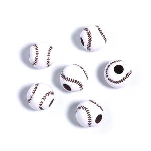 Macro view of white acrylic baseball beads with brown stitching for DIY jewelry making