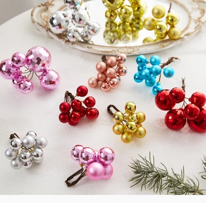 Close-up of glittery and matte Christmas ball cluster picks with natural branch texture
