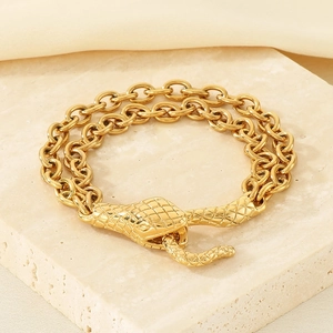 Detailed close-up of double-layered gold snake head bracelet with textured scale finish