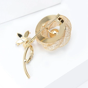 Detailed back view of gold rose brooch showing secure pin buckle and metal mesh work