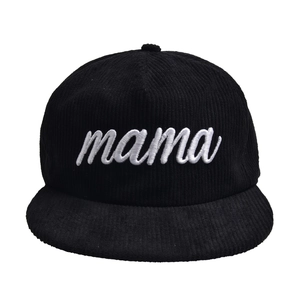 Close-up of white MAMA embroidery on black corduroy flat brim baseball cap texture