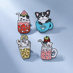 Detail of four cute cat and dog enamel pins featuring various colorful fruit drink designs
