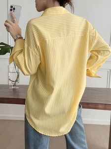 Detailed back view of a loose-fit striped long-sleeve shirt with rear yoke and pleats
