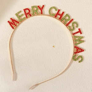 Detail of gold metal headband with red and green rhinestones spelling Merry Christmas