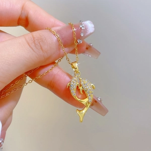 Luxurious gold dolphin pendant necklace with micro-pave crystals on a thin chain