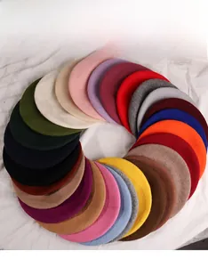 Flat lay of multiple colorful wool berets for women in a circular arrangement