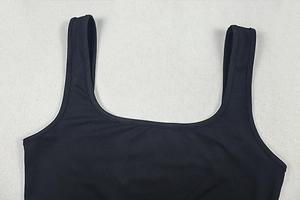 Close-up of black sleeveless bodysuit with U-neckline and wide shoulder straps