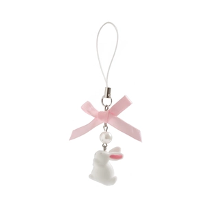 Close-up of white resin rabbit charm with pink ribbon bow and pearl on lanyard