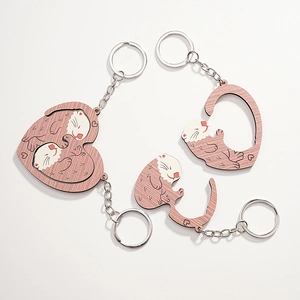 Creative wooden animal keychain set with otters forming a heart shape for couples