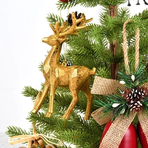 Golden reindeer Christmas ornament with geometric facets hanging on a festive tree branch