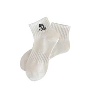 White ankle socks with black cartoon embroidery on a clean minimalist background