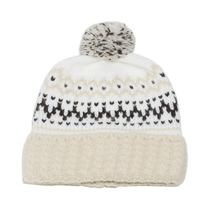 Detailed knit texture of Fair Isle geometric pattern on winter beanie with faux fur pom