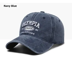 Close-up of white 3D embroidery on vintage navy blue washed cotton baseball cap