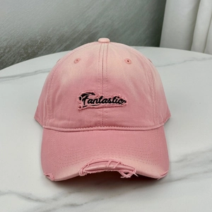 Pink distressed baseball cap with Fantastic embroidery on high-quality marble background
