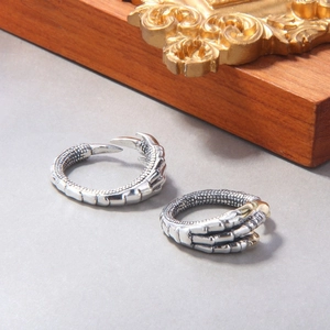 Detailed view of the dragon claw open ring with vintage silver finish and scales