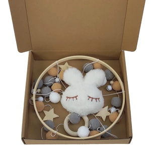 Baby wooden crib mobile with grey felt balls, stars and a plush bunny in a gift box