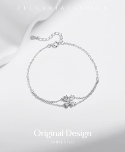 Close-up of double-layered s925 silver bracelet featuring a sparkling clover pendant