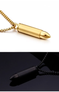 Close-up of gold and black bullet necklaces showing matte and polished steel finishes