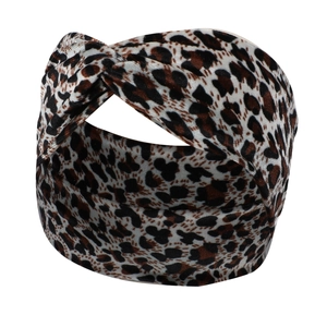 Detailed view of leopard print knotted headband with velvet texture and crisscross design