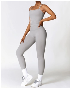 Détail d'un ensemble de yoga gris moulant avec leggings taille haute et débardeur court