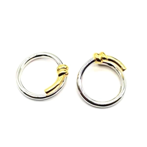 Detailed view of S925 sterling silver twisted rope ring with gold knot accents