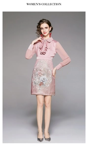 Detail of pink embroidered dress featuring tiered bow neckline and vintage floral patterns