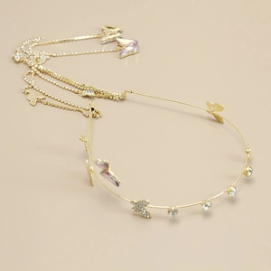 Detail view of golden headband with rhinestone butterflies and long tassel chain