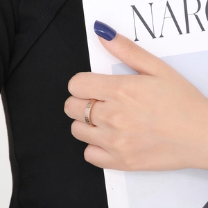 Detail of rose gold 18k plated stainless steel ring with elegant grid pattern on hand