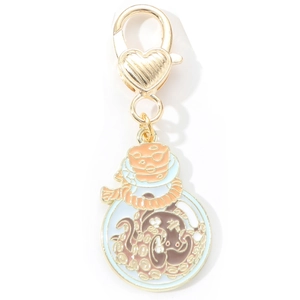 Detailed macro view of a gold lobster clasp with heart and colorful enamel octopus pendant