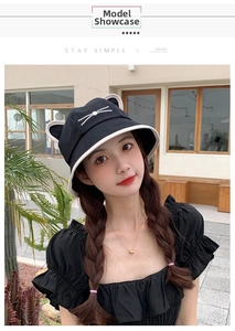 Close-up of black bucket hat featuring cute cat ears and white whisker embroidery detail