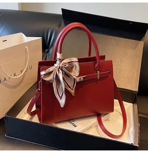 Deep red leather handbag with gold twist lock and silk scarf in a premium gift box