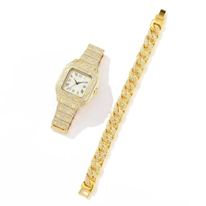Close-up of a gold square dial watch with Roman numerals and a matching diamond Cuban chain