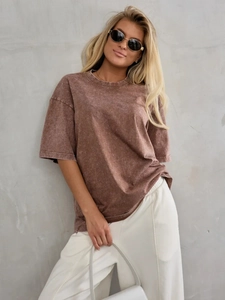 Detail of brown oversized cotton T-shirt featuring vintage washed texture and round neck