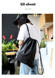 Black waterproof nylon drawstring bag with honeycomb texture and side zipper pocket