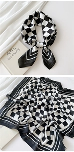 Detail view of checkered silk scarf showing texture and elegant knot style