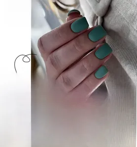 Macro detail of matte dark green press-on nails showing frosted texture and various sizes