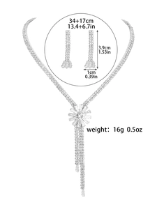 Detailed view of silver flower rhinestone necklace and earrings set with measurements