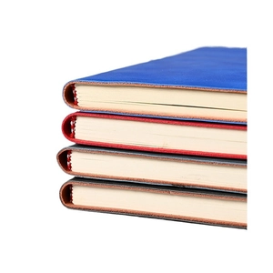 A5 premium faux leather notebooks in blue, red, grey, and black colors stacked on a white surface