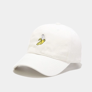 Close-up of a white cotton baseball cap featuring detailed yellow banana embroidery
