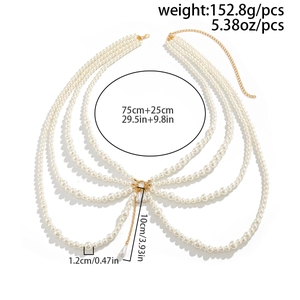 Detail of layered pearl body chain with golden metal links and teardrop pendant