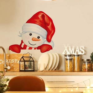 Festive Christmas snowman wall sticker on light kitchen wall with holiday decorations