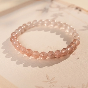 Macro shot of minimalist strawberry quartz beaded bracelet with natural red inclusions