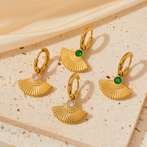 French retro gold fan-shaped stainless steel earrings with zircon stone on stone background