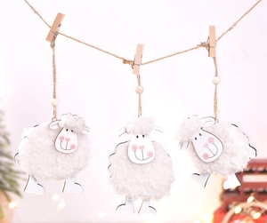 Detail of cute white wool felt sheep hanging decorations with wooden clips and hemp rope