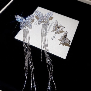 Detailed macro view of S925 silver butterfly tassel earrings with sparkling zircon stones