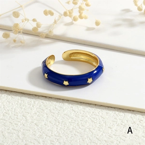 Close-up of blue enamel star ring with gold finish and adjustable opening detail